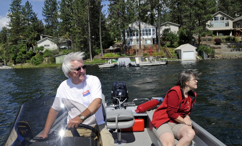 Badger Lake property owners Carl and Dana Strode, shown boating Wednesday, oppose plans of other property owners who want to use herbicides to control aquatic vegetation along the shoreline. (Dan Pelle)