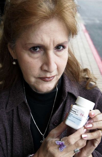 
Cancer patient Eva Ossorio, 62, holds a bottle of Femara, a hormone blocker she uses for breast cancer rather than the chemo she formerly would have been undergone for her relatively large tumor. 
 (Associated Press / The Spokesman-Review)