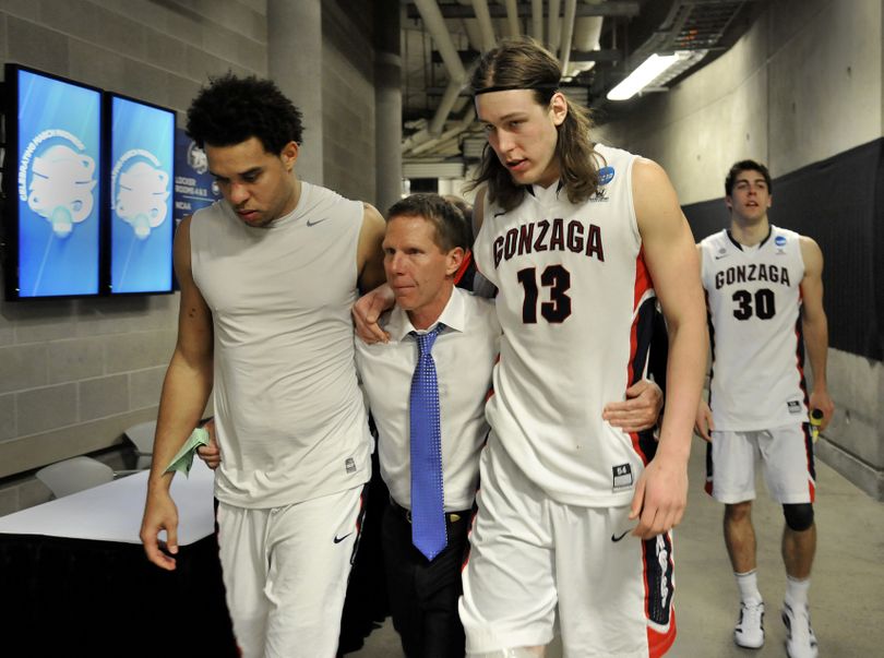 Gonzaga coach Mark Few walks with senior Elias Harris, left, and junior Kelly Olynyk, with Mike Hart trailing behind, after the top-ranked and top-seeded Bulldogs were eliminated from the NCAA tournament by Wichita State on Saturday night at EnergySolutions Arena in Salt Lake City. (Dan Pelle)