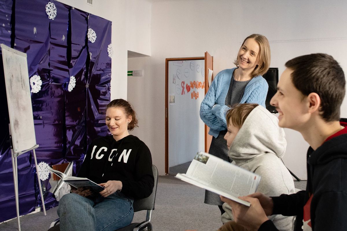 Iryna Rud, standing, laughs with her class of Ukrainian students on March 21. More than 150,000 Ukrainian children have entered the Polish educational system since the war between Russia and Ukraine began in February.  (Eli Francovich/The Spokesman-Review)