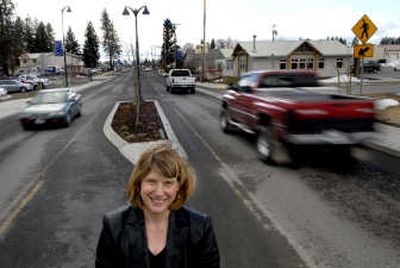 
Hayden Community Development Director Lisa Key stands near one of the new center islands that includes new trees and streetlights. City officials are hoping to take the transformation even farther, proposing new downtown Hayden design standards. 
 (Kathy Plonka / The Spokesman-Review)