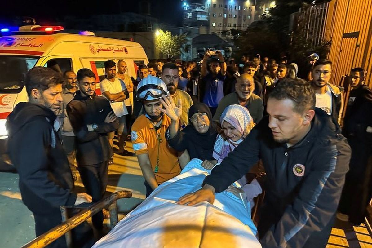 Palestinian women react next to the body of a man, who, according to medics, was killed Tuesday in an Israeli strike earlier today, at Nasser Hospital in Khan Younis, southern Gaza Strip.  (Stringer)