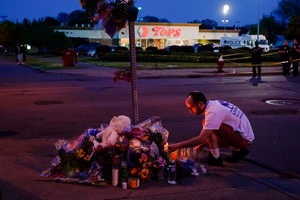 A person pays his respects at a makeshift memorial outside the scene of a shooting at a supermarket in Buffalo, N.Y., on Sunday.  (Matt Rourke)