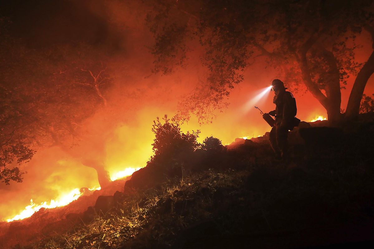 A firefighter monitors a flare-up on a the head of a wildfire above the Sonoma Valley, Wednesday Oct. 11, 2017. (Kent Porter / Associated Press)