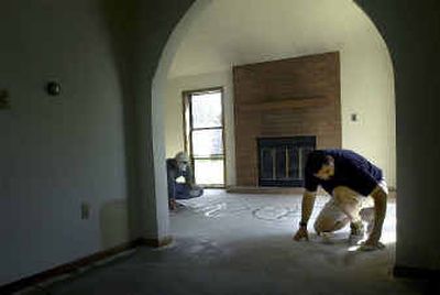 
Knight preps the floor for a stain. Due to the increased interest in his product and greater customer education about stained concrete, he was able to take the business from part time last year to full time this year. 
 (The Spokesman-Review)