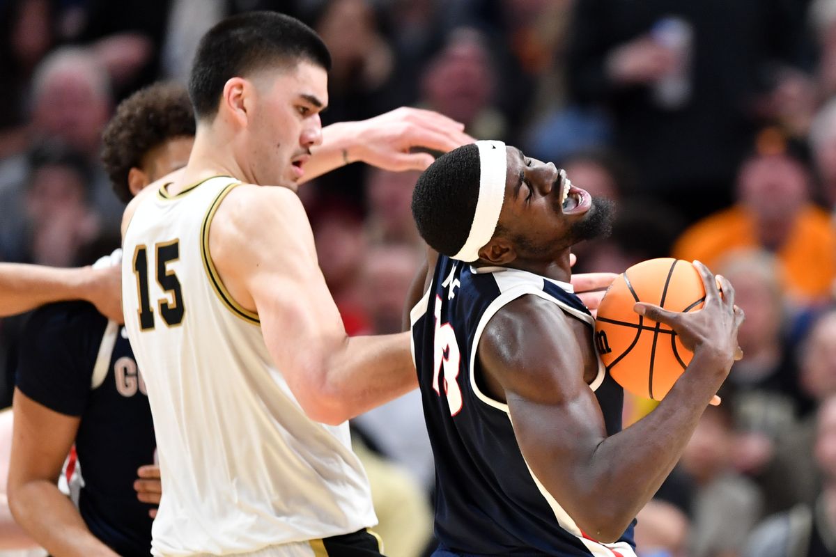 Gonzaga forward Graham Ike takes a rebound away from Purdue center Zach Edey during the second half of Friday’s NCAA Tournament Sweet 16 game in Detroit.  (Tyler Tjomsland/The Spokesman-Review)