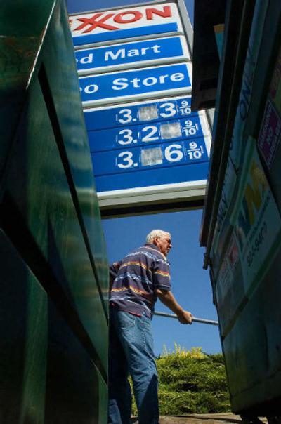 
Joe Wyles changes the price sign at his Exxon station and store near Cheney. He was dropping the price of regular unleaded from $3.23 a gallon to $3.19. 
 (The Spokesman-Review)