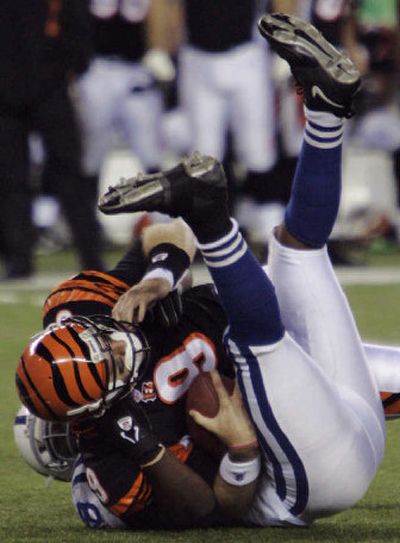 
Bengals quarterback Carson Palmer is sacked by Colts defender Robert Mathis in the fourth quarter on Sunday in Cincinnati.
 (Associated Press / The Spokesman-Review)