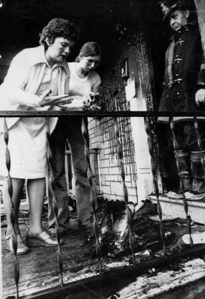 In this June 3, 1978, photo, Virginia Gratto, left, looks at her burned purse after it was removed from her fire-damaged apartment in Cohoes, N.Y. (FILE Associated Press)