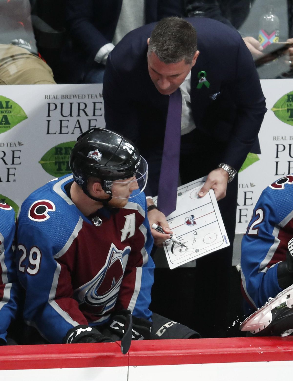 Colorado Avalanche head coach Jared Bednar, right, draws up a play for center Nathan MacKinnon in the third period of Game 3 of an NHL hockey first-round playoff series against the Nashville Predators, Monday, April 16, 2018, in Denver. Colorado won 5-3. (David Zalubowski / Associated Press)