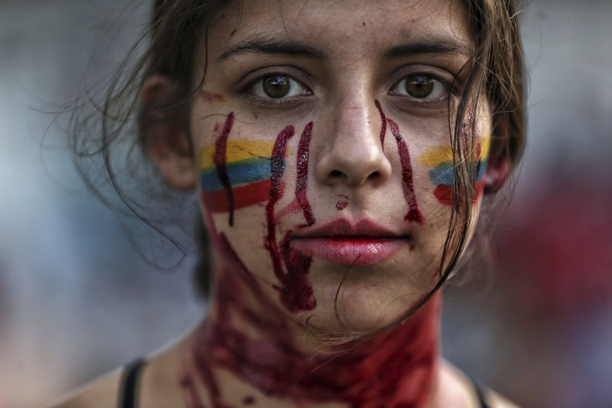 A student performs a play called "Who killed them" during anti-government protests in Cali, Colombia, Tuesday, May 11, 2021. Colombians have protested across the country against a government they feel has long ignored their needs, allowed corruption to run rampant and is so out of touch that it proposed tax increases during the coronavirus pandemic.  (Andres Gonzalez)