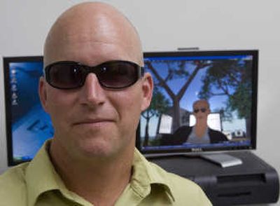 David Cillay, an assistant dean at Washington State University, poses in front of his alter-ego in the popular online game 