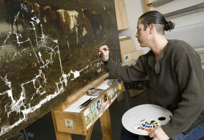 Amy Sokoloff, co-owner of Chelsea Restoration Associates Inc., restores a painting at the studio Feb. 5 in New York.  (Associated Press / The Spokesman-Review)