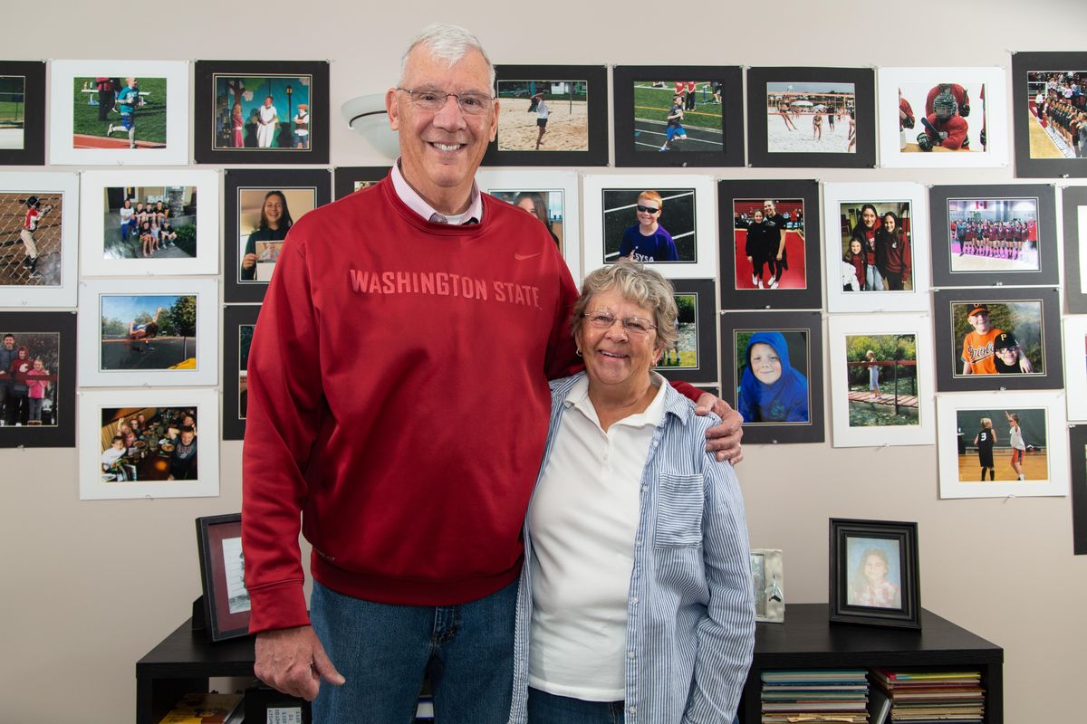 Jim and Judy Stinson celebrated their 50th year of marriage in June, and here they smile in front of the many athletic pictures of their seven grandchildren in their Spokane, Wash., home on Oct. 17, 2018. Sports has been integral to the Stinson’s lives: they met in 1967 as a result of Carroll College basketball team’s loss that Jim played on. Two of three of the Stinson’s children have coached at the collegiate level and all three have coached in some capacity, and all seven of their subsequent grandchildren are involved in various sports. (Libby Kamrowski / The Spokesman-Review)