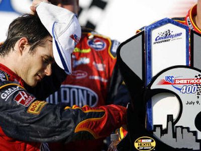 
NASCAR Nextel Cup driver Jeff Gordon touches his trophy after edging Matt Kenseth to win the USG Sheetrock 400.
 (Associated Press / The Spokesman-Review)