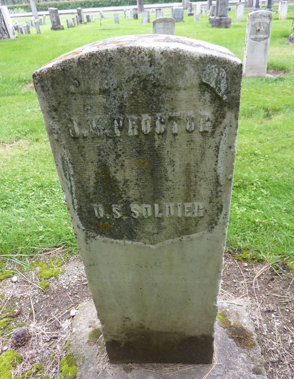 A simple gravestone in memory of J.W. Proctor at Greenwood Memorial Terrace.