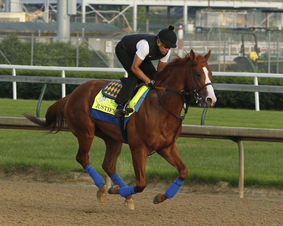 Justify, ridden by exercise rider Humberto Gomez, gallops at Churchill Downs in Louisville, Ky., Saturday, May 26, 2018 getting ready for The Belmont Stakes and a possible Triple Crown, in New York in June. (Garry Jones / Associated Press)