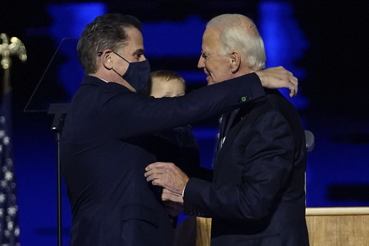 FILE - In this Nov. 7, 2020, file photo, President-elect Joe Biden, right, embraces his son Hunter Biden, left, in Wilmington, Del. Biden’s son Hunter says he has learned from federal prosecutors that his tax affairs are under investigation.  (Andrew Harnik)