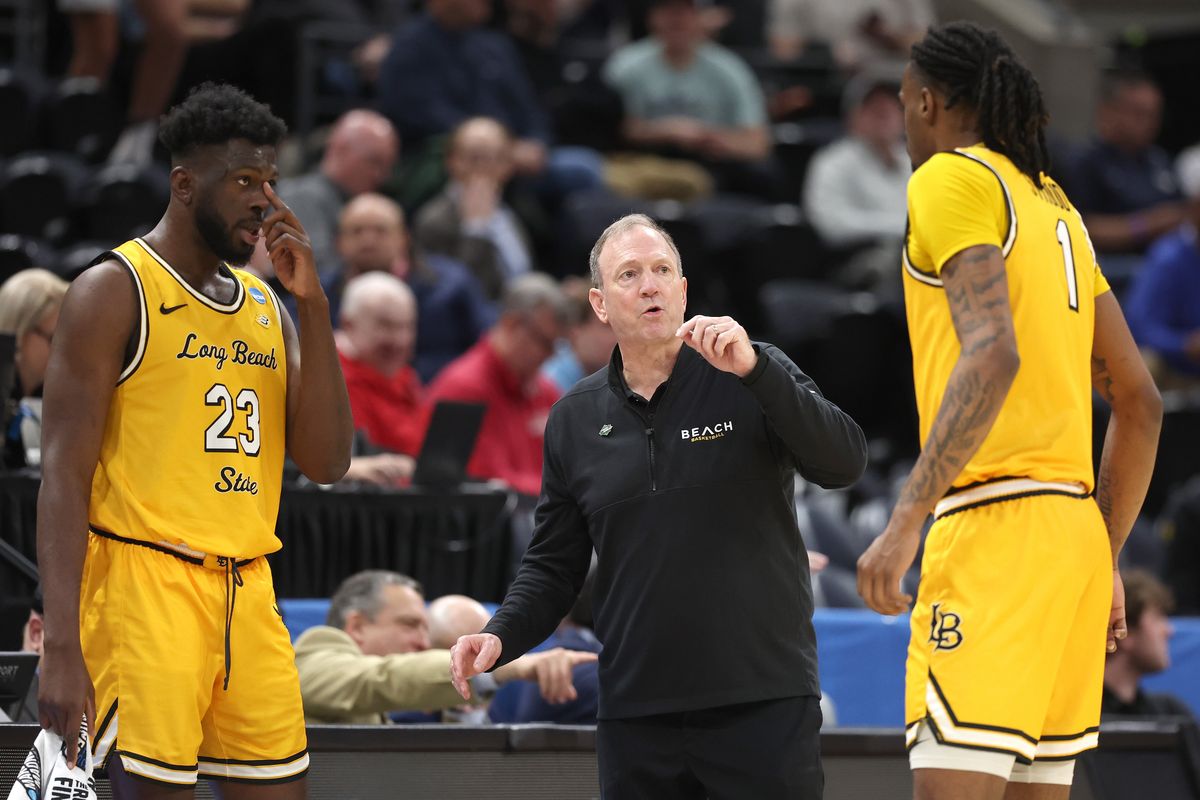 Ex-Long Beach State head coach Dan Monson talks with the 49ers’ Lassina Traore, left, and Amari Stroud during the NCAA Tournament on March 21 in Salt Lake City.  (Getty Images)