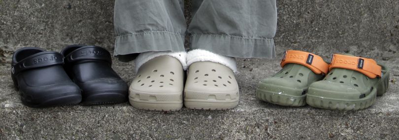 In this photo taken April 8, 2010, Emily Auth displays some of her collection of Crocs outside her home in Kokomo, Ind. Auth calls herself a Crocs hypocrite because she mocked the shoes when she first saw them. But the 25-year-old loves them so much she ended up wearing red high-heel Crocs at her wedding last summer. (Michael Conroy / Associated Press)