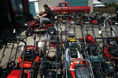 
Gopher's mechanic Jamie Smith prepares a riding mower for a summer tune-up
 (Brian Plonka photos/ / The Spokesman-Review)