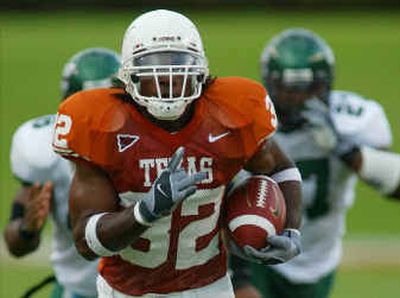 
Texas running back Cedric Benson, who has rushed for 1,764 yards and 19 touchdowns, figures to be a handful for Michigan today in the Rose Bowl. 
 (Associated Press / The Spokesman-Review)