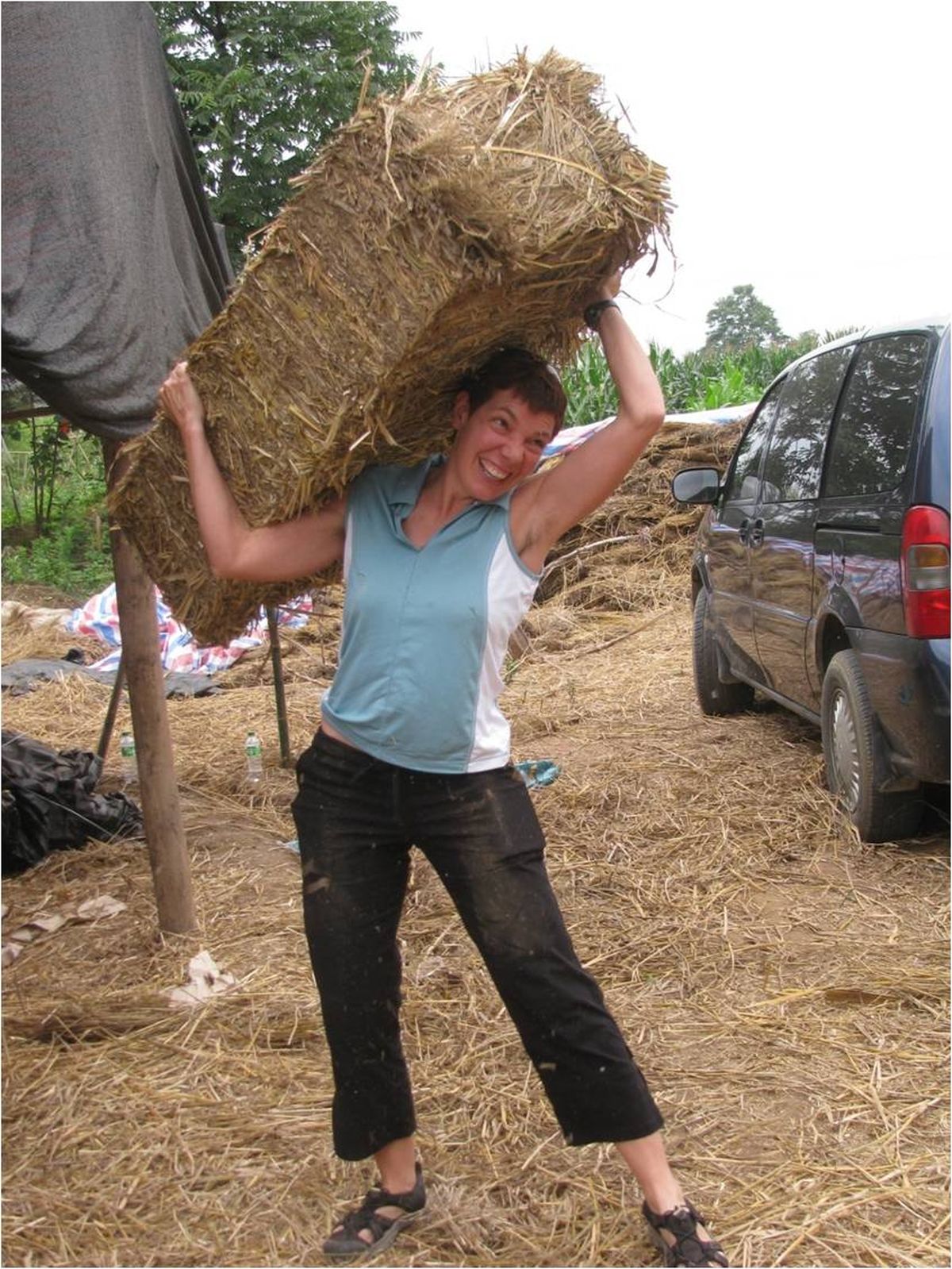 Spokane resident and architect Kelly Lerner hoists a straw bale during a workshop she recently presented in China.  (Alli Kingfisher / Special to Down to Earth NW.com)
