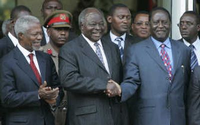 
Kenyan President Mwai Kibaki, center, shakes hands Thursday with opposition leader Raila Odinga as former U.N. Secretary-General Kofi Annan, left, looks on. 
 (Associated Press / The Spokesman-Review)