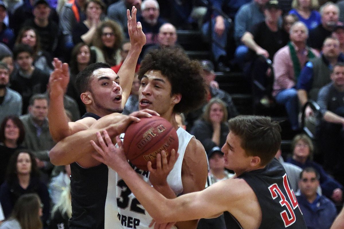 Ferris forwards Mike Ervin (left) and Jadon Bowton try to strip the ball from Gonzaga Prep’s Anton Watson. (Colin Mulvany / COLIN MULVANY/The Spokesman-Review)