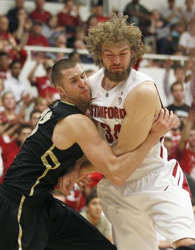 Colorado’s Austin Dufault, left, battles under the basket for a rebound against Stanford’s Andrew Zimmermann in the second half. (Associated Press)