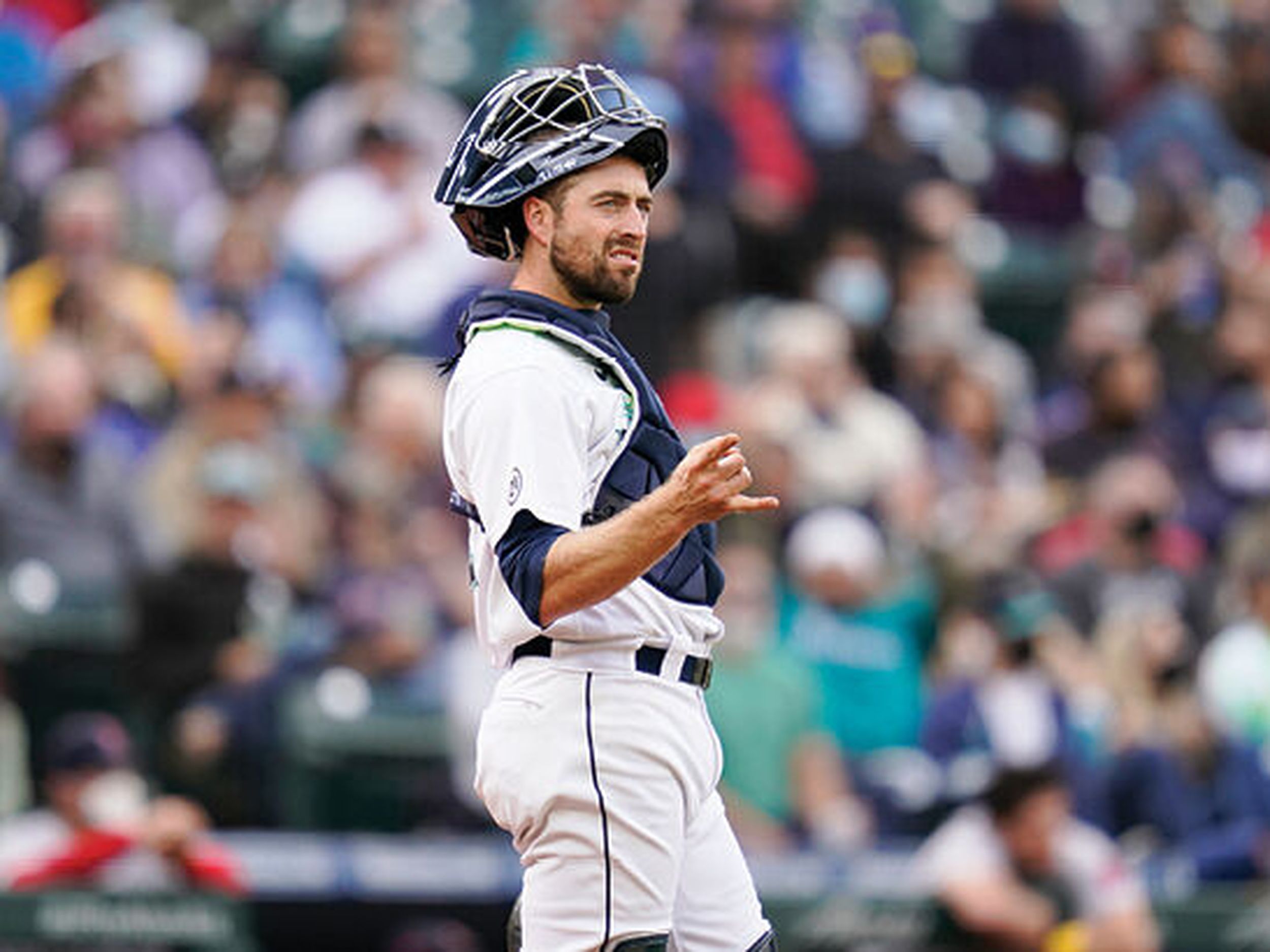 Seattle Mariners catcher Tom Murphy motions toward the field