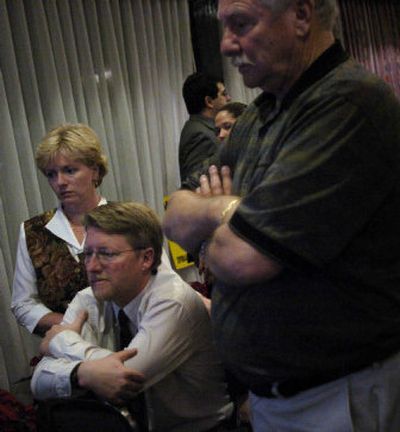 
Mike DeVleming sits with his wife and father, waiting for Spokane Valley City Council results to come in Tuesday night at his party at the Valley Quality Inn. 
 (Amanda Smith / The Spokesman-Review)
