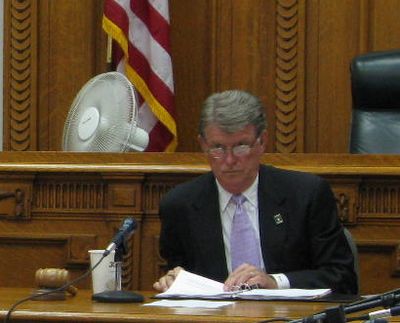 Idaho Gov. Butch Otter presides over a meeting of the state Land Board on Tuesday. During a break in the meeting, he called proposed oversized shipments on U.S. Highway 12 