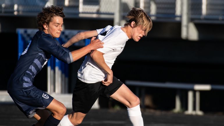 Lewis and Clark’s Dane Cobb moves the ball downfield as Gonzaga Prep’s Andre Layman gives chase during Wednesday’s 4A Greater Spokane League soccer match at Gonzaga Prep. (Colin Mulvany/The Spokesman-Review)