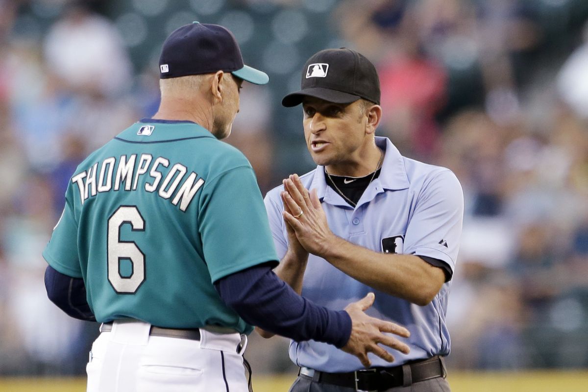 Seattle Mariners acting manager Robby Thompson discusses a call with umpire Chris Guccione during recent homestand. (Associated Press)