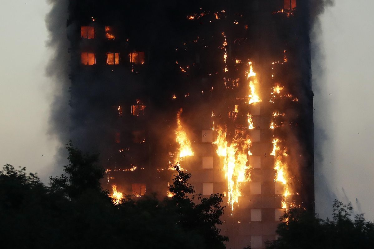 Smoke and flames rise from a building on fire in London, Wednesday, June 14, 2017. Metropolitan Police in London say they
