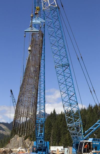 A rebar cage to be used in the construction of a bridge on I-90 is lifted into place Aug. 12 just east of Snoqualmie Pass, Wash.  (Associated Press)