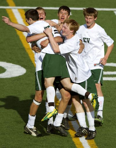 East Valley’s Adam Talley, left, celebrates with teammates after scoring the first of two goals against Selah in the second half of a State 2A soccer match at Joe Albi Stadium on Tuesday. (Colin Mulvany)