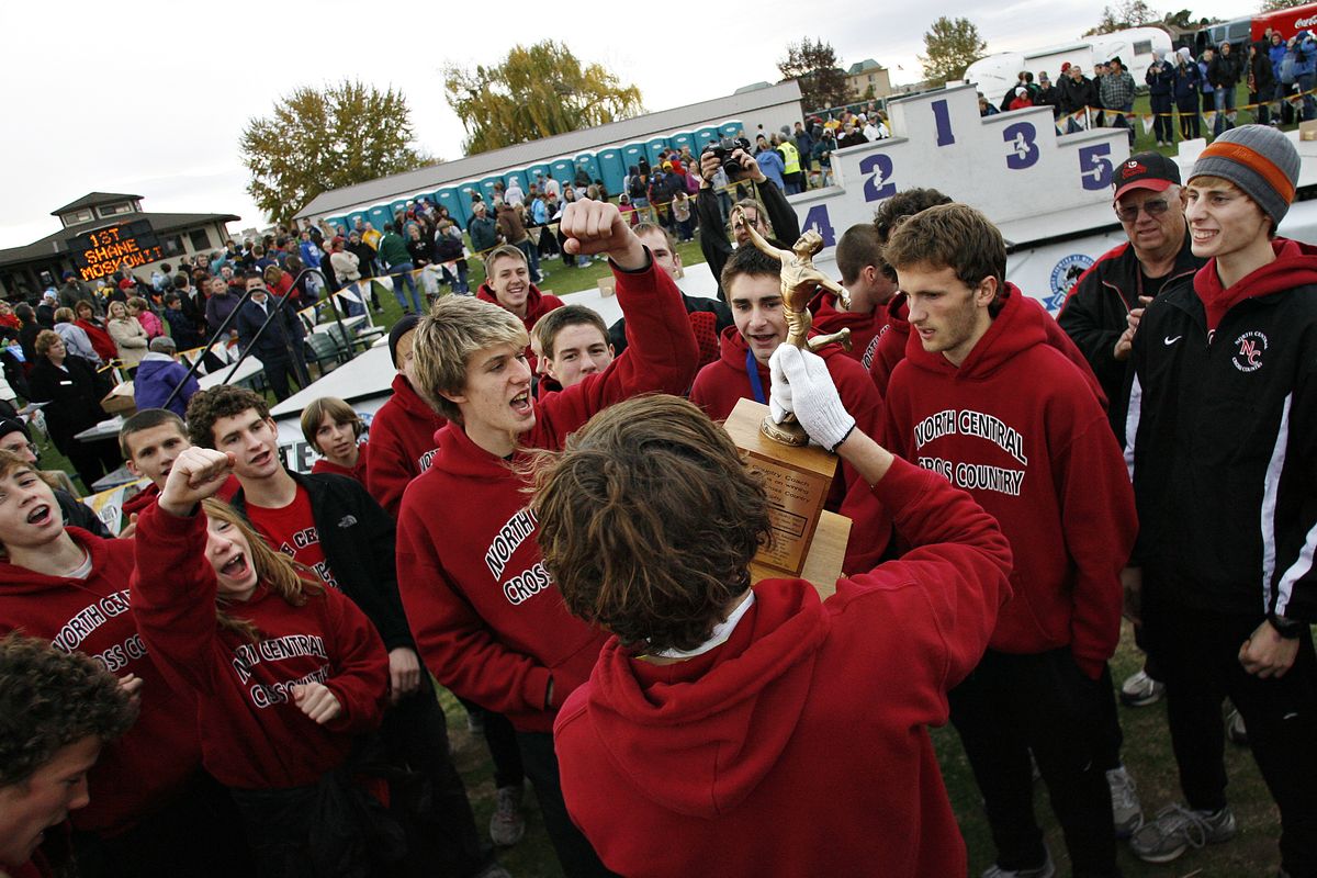 North Central’s boys celebrate their fourth consecutive state cross country championship in Pasco. Tri-City Herald (Kai-Huei Yau Tri-City Herald / The Spokesman-Review)