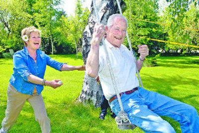 
Artist Kay O'Rourke gives her father, James McKay, a push on her swing. O'Rourke will host her annual Art in the Garden on Saturday. Artists will show their creations, and gardeners will hold a plant sale to benefit Hutton Settlement. 
 (Dan Pelle / The Spokesman-Review)