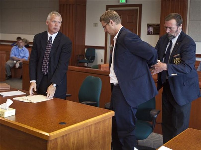 Former Idaho State Senator John McGee is taken into custody after appearing in court at the Ada County Courthouse in Boise with attorney Scott McKay, left, Tuesday, Aug. 21, 2012. (AP/Idaho Statesman / Darin Oswald)