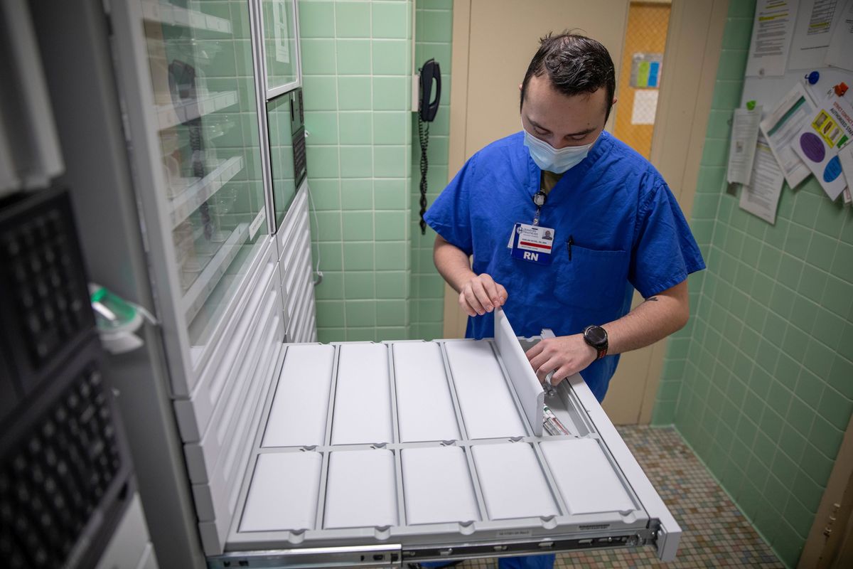 Air Force 2nd Lt. Kaelan Hayes, a clinical nurse assigned to a military medical team, gathers medication on March 15 as part of the COVID-19 response operations at Signature Healthcare Brockton Hospital.  (Sgt. Kaden Pitt)