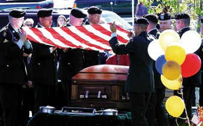 
Members of the U.S. Army 10th Mountain Division from Fort Drum , N.Y., take the flag off the casket of Spc. Brandon Titus to fold it at the Idaho State Veteran's Cemetery, Monday in Boise. Titus, 20, was killed by a roadside bomb earlier this month in Iraq. 
 (Associated Press / The Spokesman-Review)