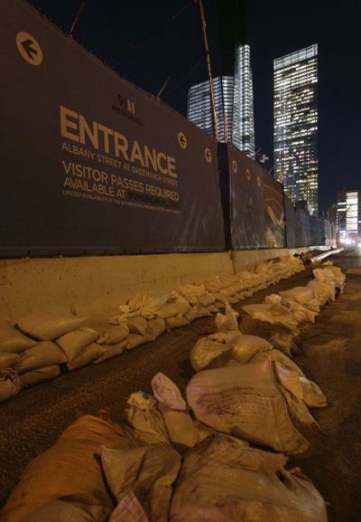 Sandbags rim the perimeter of the World Trade Center Memorial and construction site after the memorial was closed by flooding in the wake of Superstorm Sandy, Monday, Nov. 5, 2012, in New York.  Joe Daniels, president of the National September 11 Memorial and Museum, said that water that rushed into the site has been pumped out and the memorial will reopen to the public Tuesday. (Kathy Willens / Associated Press)