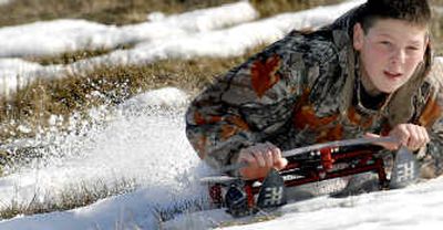 
Daniel DesJarlais, 14, demonstrates one of the sleds made by his dad, Dale, in Post Falls on Thursday. 
 (Photos by KATHY PLONKA / The Spokesman-Review)
