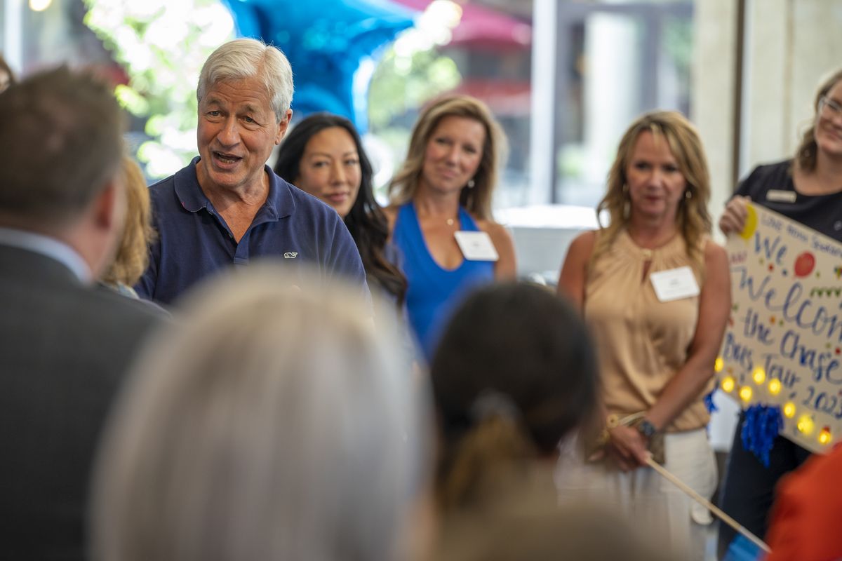 Jamie Dimon, left, talks to a crowd of bank staffers at the Spokane branch of Chase bank on July 30 at the office on Main Avenue in Spokane.  (Jesse Tinsley/The Spokesman-Revi)