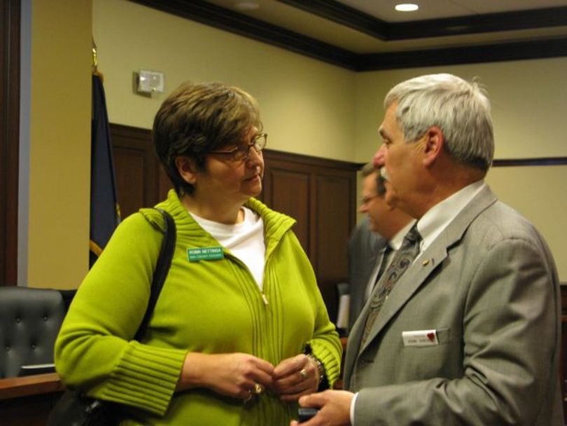Senate Education Committee Chairman John Goedde, right, talks with a concerned Robin Nettinga of the Idaho Education Association, left, after his committee voted Thursday to pass all three bills in a controversial school-reform plan that the association opposed. Goedde is the lead legislative sponsor of the bills. (Betsy Russell)