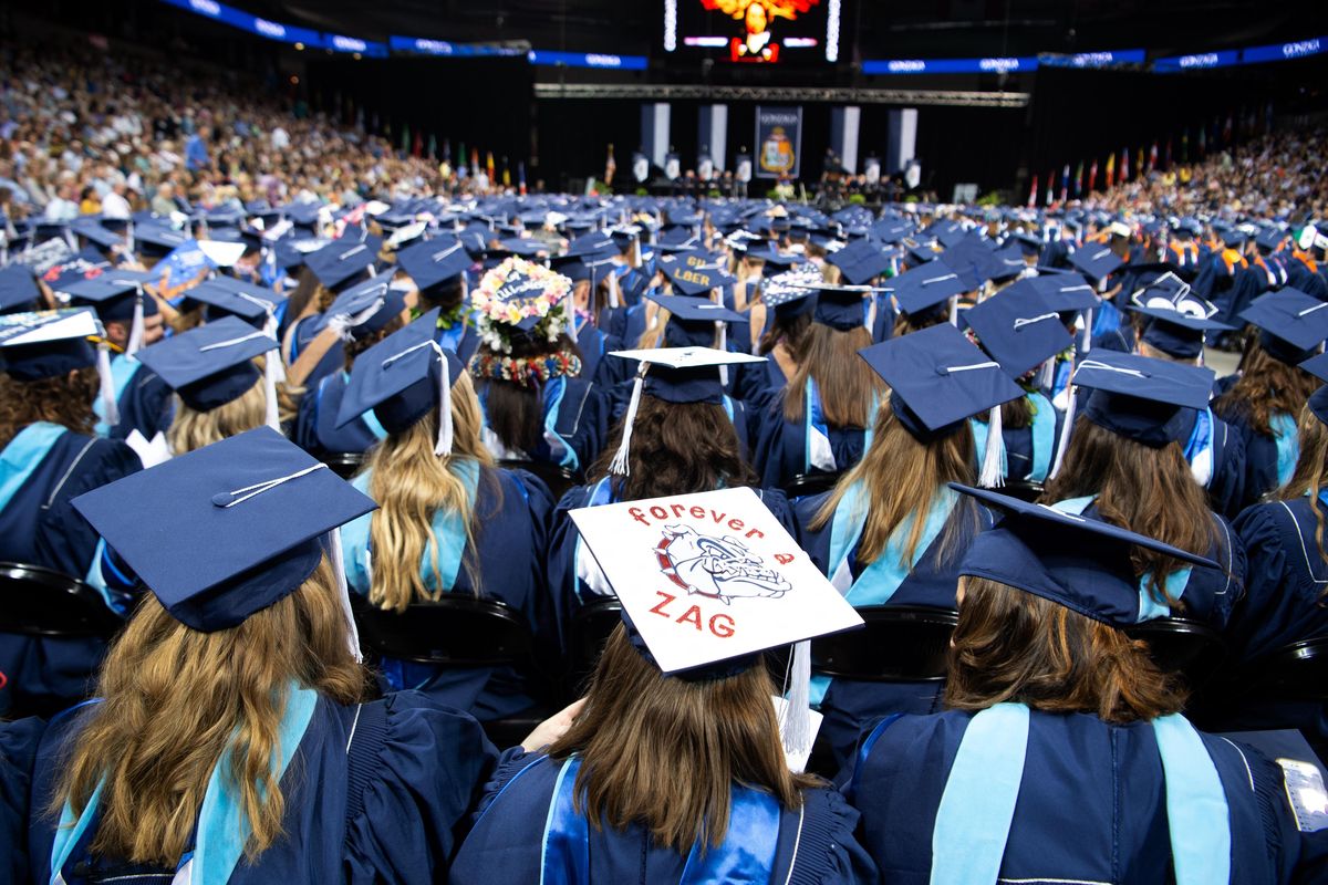 A variety of mortarboard decorations can be seen among the more than 1,200 graduates of the 2019 class of Gonzaga University who fill the floor of the Spokane Arena. Several thousand family members and friends also attended the graduation Sunday, May 12, 2019. (Jesse Tinsley / The Spokesman-Review)