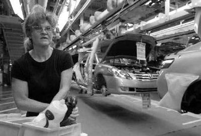 
Vedra Miracle reaches for a bolt as she puts bumpers on Toyota cars moving along an assembly line at the Toyota plant in Georgetown, Ky. Toyota has boosted its lobbying efforts in Washington, D.C.
 (Associated Press / The Spokesman-Review)