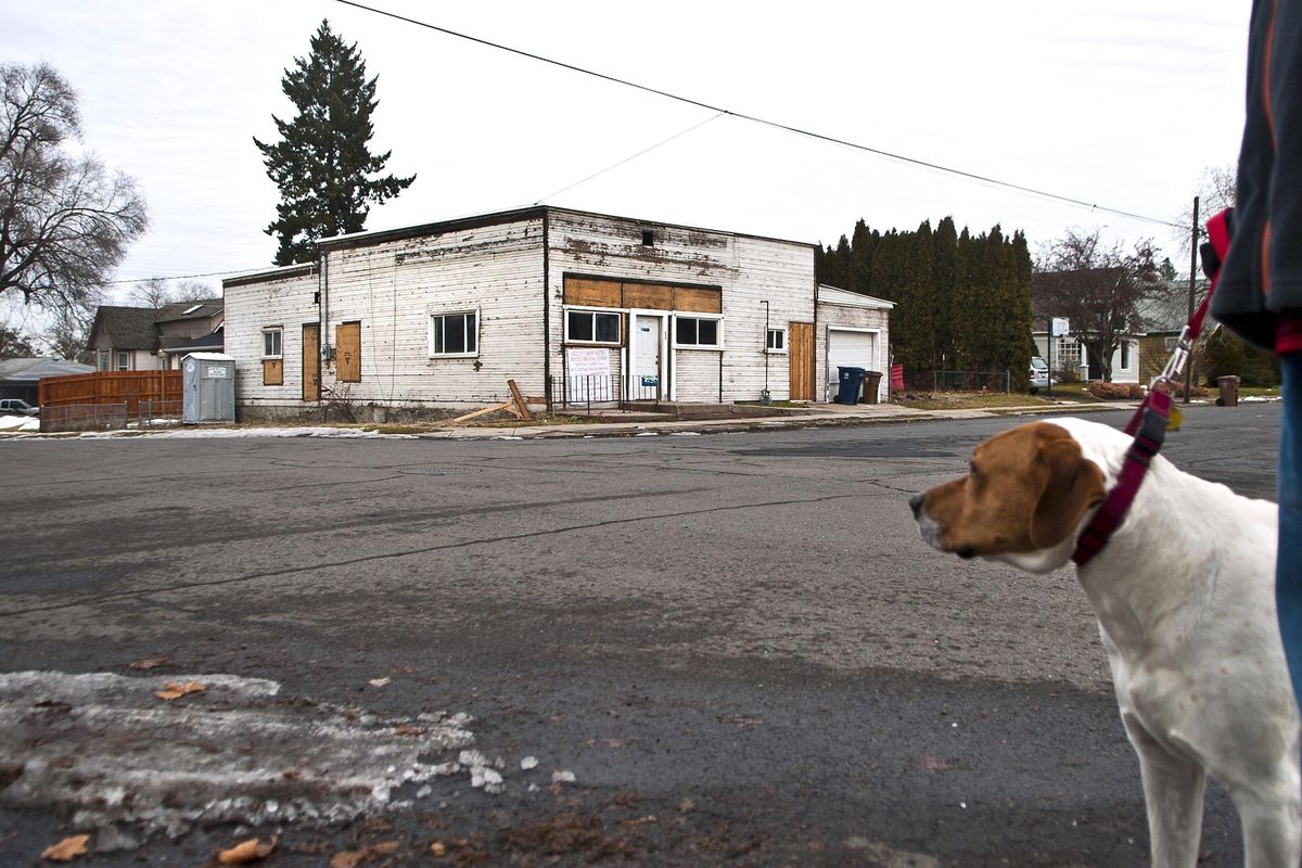 Bo, the St.Bernard/Mastiff mix, walks past the former grocery/residence in the Perry District in January. (Kathy Plonka / The Spokesman-Review)